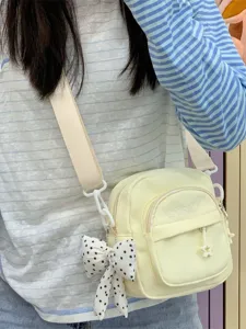 Japanese style lightweight canvas crossbody bag for women with multi pockets and bow charm.
