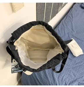 Black drawstring backpack interior detail, large capacity casual school travel bag.