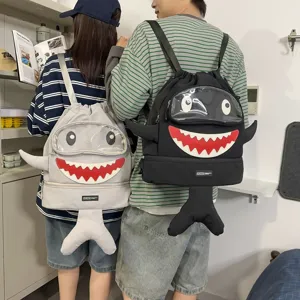 Detail view of the cute cartoon shark backpack featuring clear window and 3D fin design.