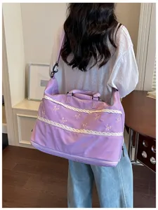 Purple travel duffel bag with delicate lace trim and sweet bow embroidery for weekend trips.