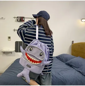 Detailed view of the funny cartoon shark backpack, featuring a clear window and unique tail.