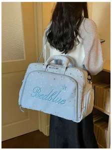 Large capacity blue star print travel duffel bag with shoulder strap for women weekend trips.