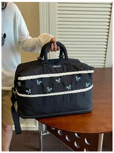 Black travel duffel bag with cute lace trim and blue bows, large capacity, durable fabric.