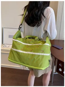 Large capacity green travel duffel bag with cute lace trim and bows for short trips.