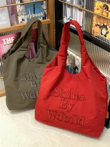 Casual canvas tote bag for women, large capacity shoulder bag with stylish embroidery text.