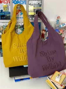 Canvas tote bag detail view, casual style, embroidered letter design, daily commuting bag.