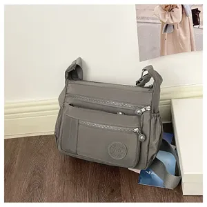 Casual nylon multi-pocket crossbody bag for women, large capacity travel shoulder detail.