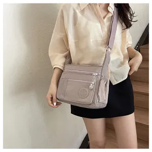 Detailed view of casual multi-pocket nylon crossbody bag with adjustable shoulder strap.