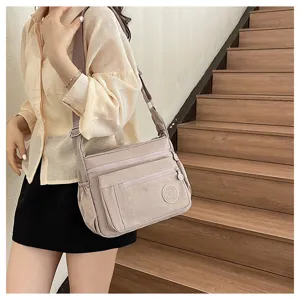 Multi-pocket nylon crossbody bag for women, casual shoulder travel bag with multiple zippers.