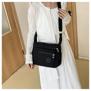 Black oxford nylon multi-pocket crossbody shoulder bag for women daily casual travel.