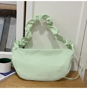 Light green cloud shoulder bag with gathered strap and cute embroidered white bows for daily commute