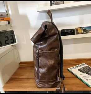Retro dark brown PU leather roll-top backpack for daily casual travel and student use.