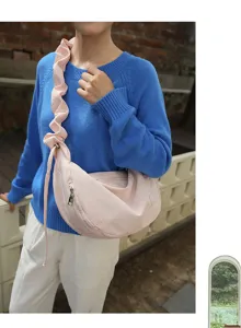 Pink pleated shoulder bag close-up, casual hobo canvas bag with delicate bow embroidery.