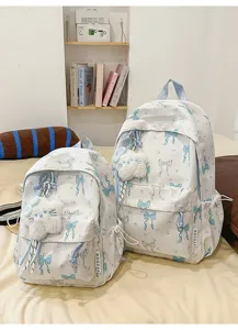Japanese style white school backpack with blue bow and cat pendant for daily use.