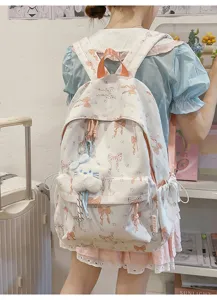 Japanese style sweet bow print backpack for school girls with cute plush pendant.