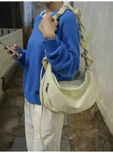 Casual shoulder cloud bag with pleated strap and cute bow embroidery for daily commuting use.