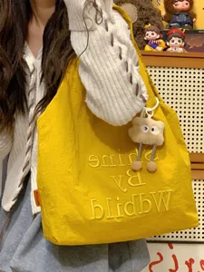 Casual yellow nylon tote bag for women, stylish embroidered shoulder handbag for daily commuting.