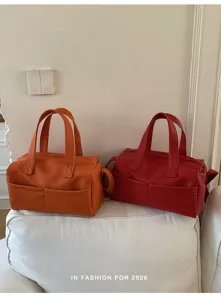 Orange and red leather handbags detail view, versatile shoulder bag showcasing daily style.