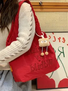 Casual red canvas tote bag for women, stylish embroidered shoulder bag with cute plush pendant.