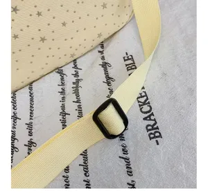 Close-up detail of casual star pattern crossbody bag strap and buckle, lightweight design.