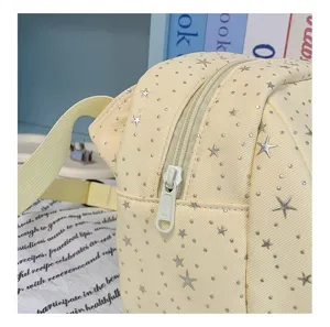 Casual star pattern canvas crossbody shoulder bag, stylish light yellow daily detail view.