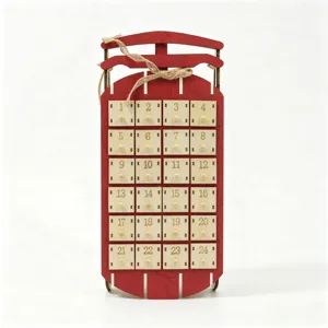 Wooden sled shaped Christmas advent calendar with 24 numbered drawers and rustic twine bow.
