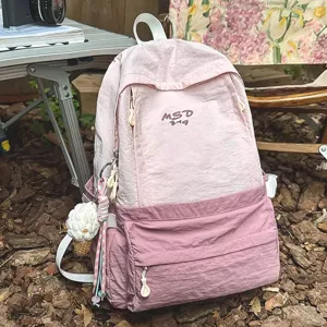 Detailed view of the pink casual backpack featuring crinkle nylon fabric and front pocket.