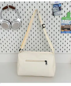 Minimalist casual large capacity canvas crossbody bag with adjustable strap and front zipper pocket.