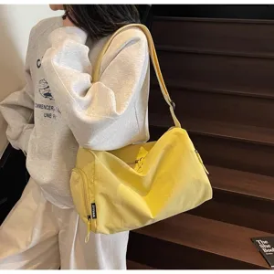 Casual large capacity travel shoulder bag for women, versatile canvas crossbody gym bag.