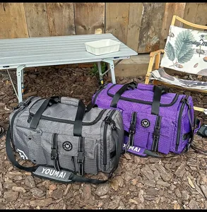 Outdoor large capacity travel duffel bag detail showing durable grid fabric and pockets.