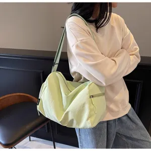 Lightweight green casual travel duffel bag detail, portable gym bag with zipper pockets.