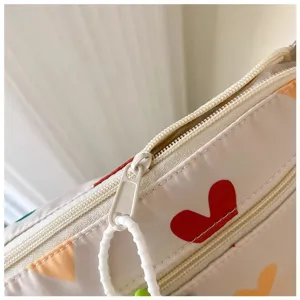 Close-up detail of canvas bag zipper and cute heart print pattern, daily storage style.