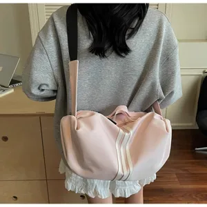 Detail view of the stylish pink sports duffel bag, showing texture and shoulder strap.