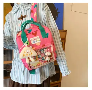 Cute pink heart pattern backpack with green handles transparent pocket and adorable kawaii charms.