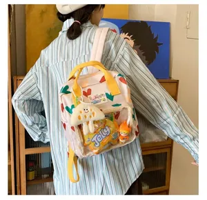 Cute girl casual canvas backpack with transparent front pocket, heart pattern and plush pendant.
