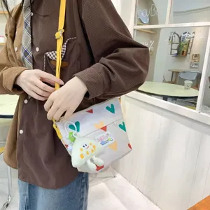 Cute canvas crossbody bag for women, casual colorful heart pattern shoulder bag with cute pendant.