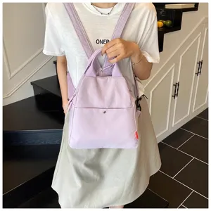 Light purple casual mini backpack for women, stylish canvas daypack for daily travel and school.
