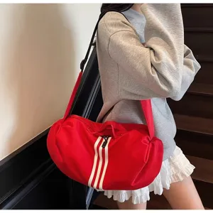 Detail view of the red casual crossbody travel duffel bag with white stripes design.