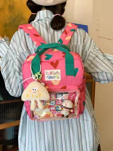 Cute girl mini backpack with colorful hearts, transparent front pocket and pendants for travel.
