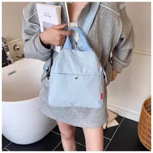 Detailed view of casual light blue canvas backpack for women, minimalist daily travel chest bag.