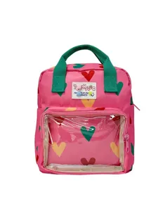 Pink cute girls backpack with colorful hearts, green handles and transparent front pocket.
