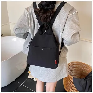 Casual black canvas backpack for women, minimalist daily travel school daypack with top handle.