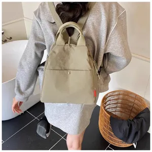 Detail view of the minimalist casual canvas backpack in light khaki, showcasing everyday design.