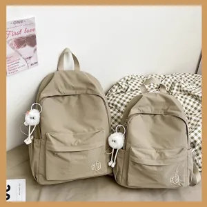 Khaki school backpack set detail showing soft fabric, front pocket and cute plush pendant.