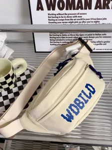 Casual beige canvas sling bag with blue letter print, ideal for everyday streetwear style.