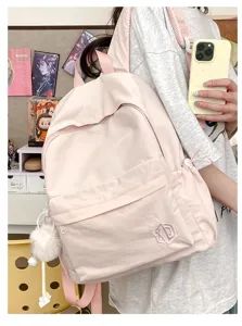 Light pink casual small backpack detail, featuring front zip pocket and cute plush pom-pom charm.