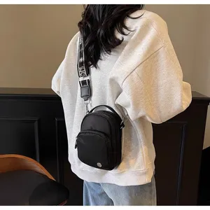Mini bolso cruzado negro para mujer con correa ancha estampada y asa para uso diario casual.