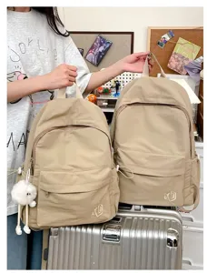Casual solid color versatile student backpack, lightweight travel school bag with pockets.