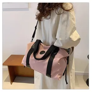 Pink travel duffel bag with black handles, large capacity waterproof gym bag for women.