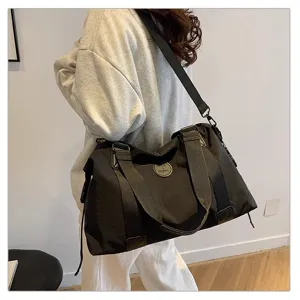 Large capacity black travel duffel bag with shoulder strap and durable waterproof fabric.